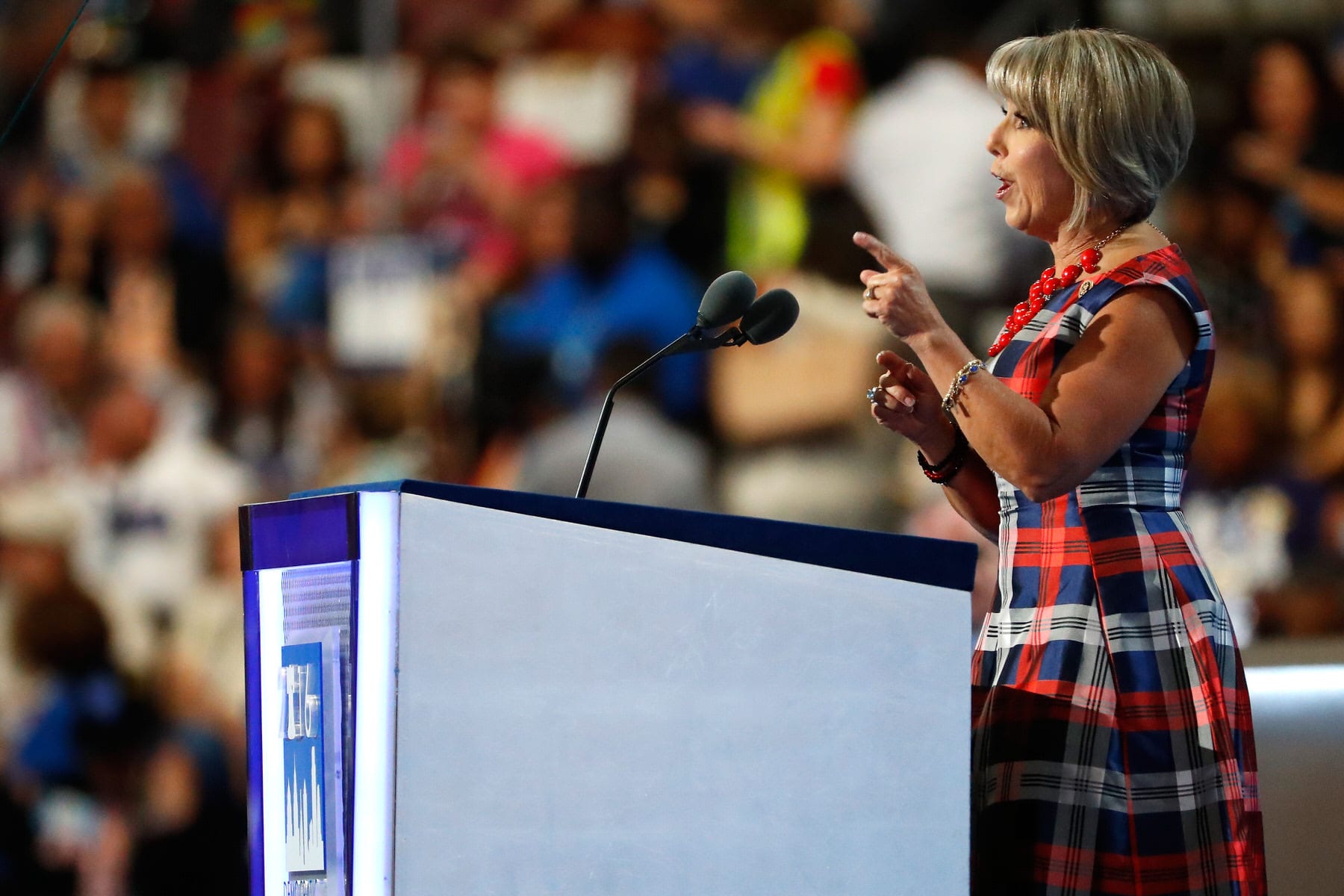 Gov. Michelle Lujan Grisham speaking at a podium.