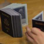 MIAMI - JUNE 22: A Passport Processing employee uses a stack of blank passports to print a new one at the Miami Passport Agency June 22, 2007 in Miami, Florida. The Bush administration postponed for at least six months a requirement that Americans who return to the United States by land or sea from Canada, Mexico and the Caribbean must carry passports. The rule, due to go into effect in January 2008, will be delayed until the summer of that year.