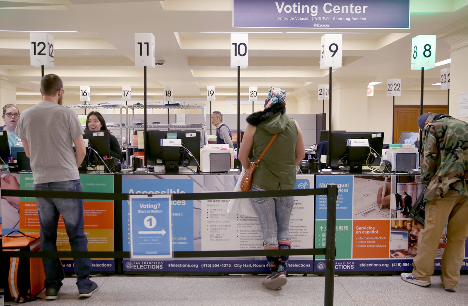 Voters being helped at a city hall voting center.