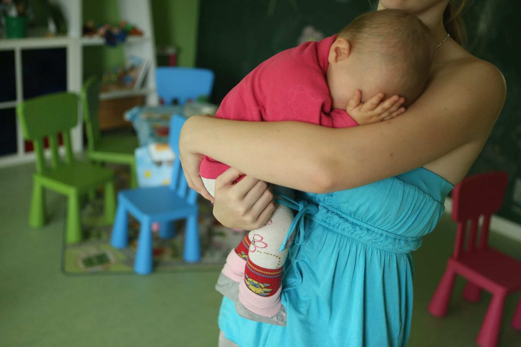 A woman holding a baby.