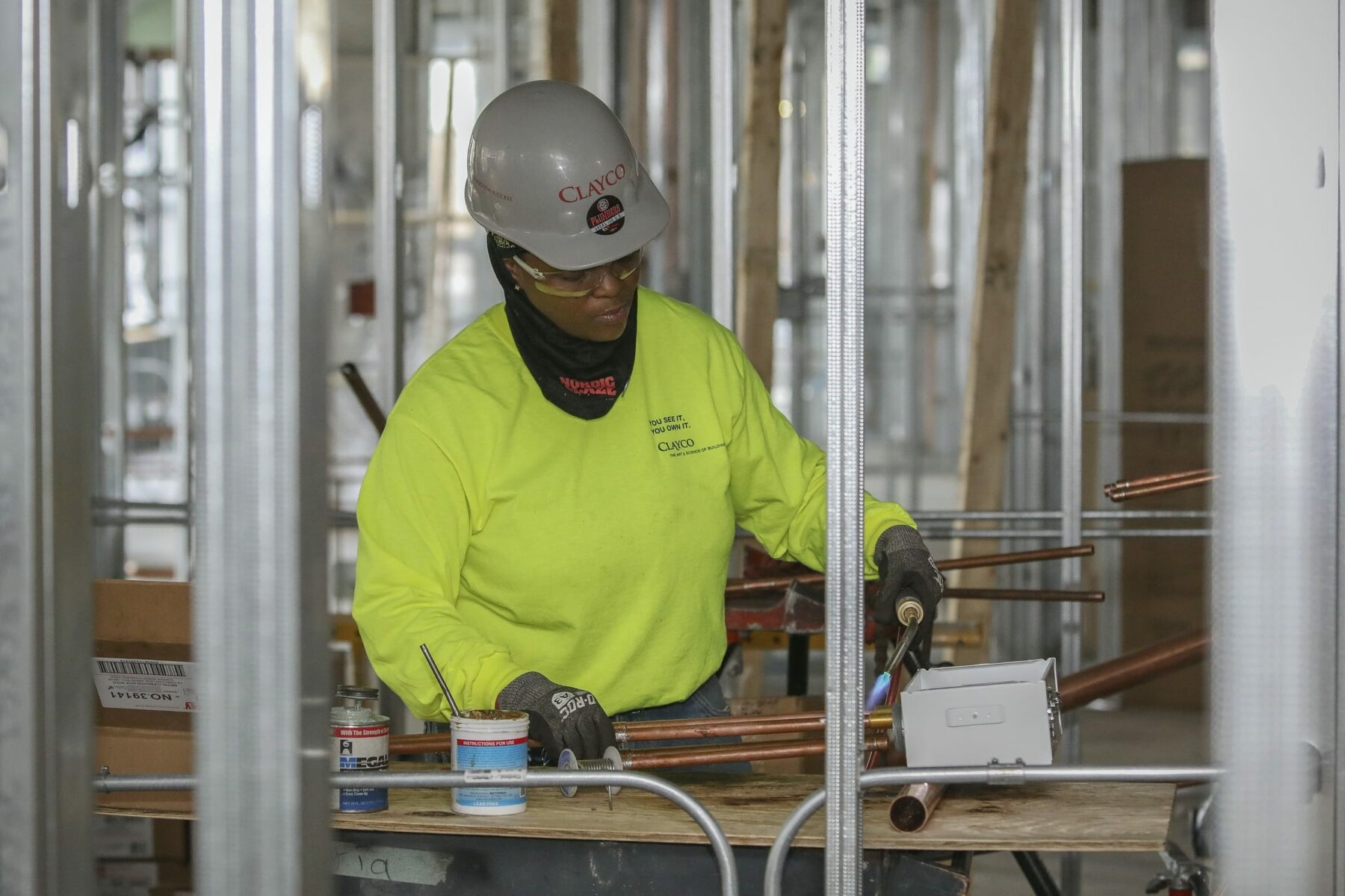 Woman works at a construction site.