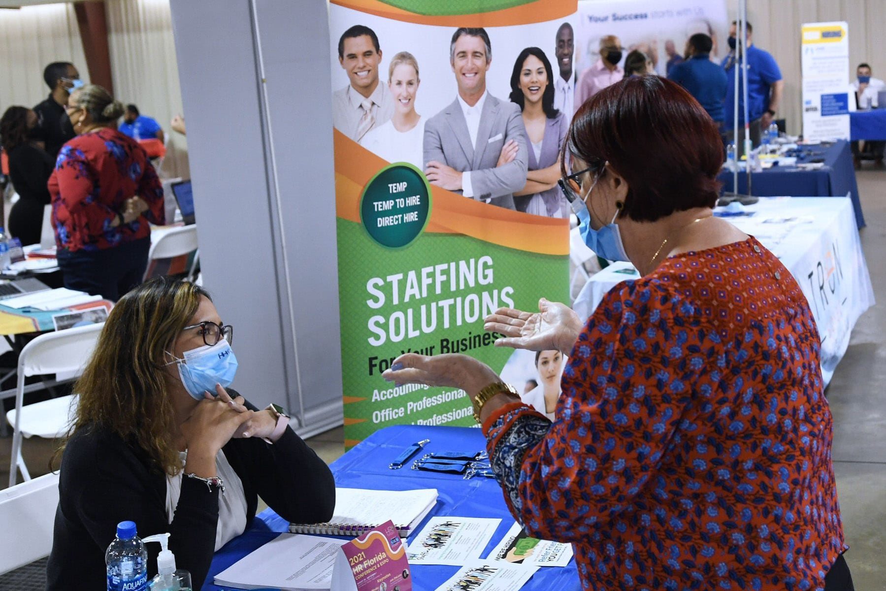 A woman seeking employment speaks to a recruiter at the 25th annual Central Florida Employment Council Job Fair at the Central Florida Fairgrounds. More than 80 companies were recruiting for over a thousand jobs.