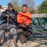 DeShanna Neal and her daughter Trinity Neal, on a park bench.