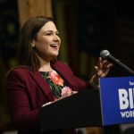 Abby Finkenauer speaking at a podium.