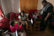 Syrita Powers and her family pictured at home in their living room.