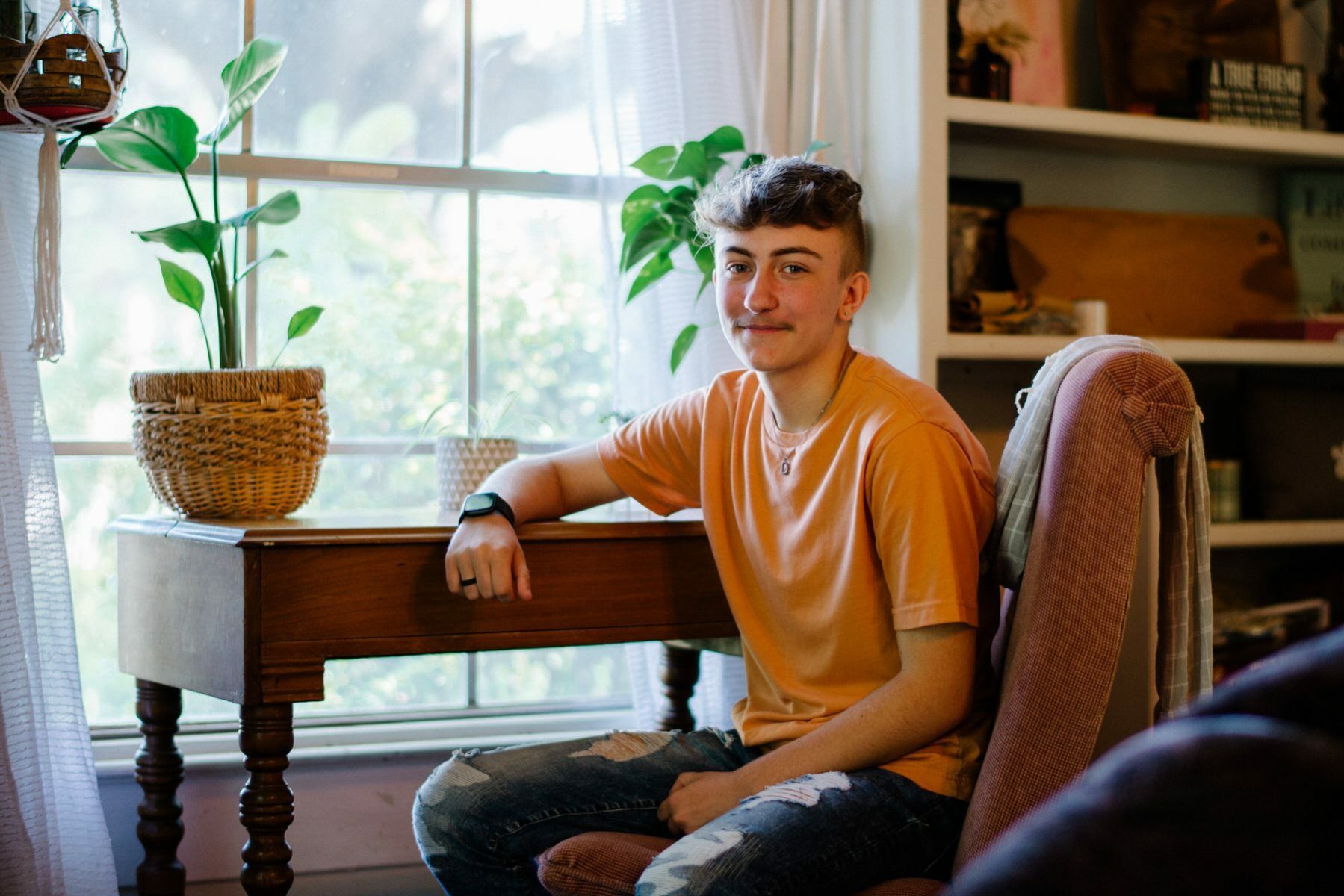 Dyaln Brandt sits at his desk.