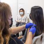 APRIL 28: A 16-year-old gets a Pfizer-BioNTech COVID-19 vaccine from Marie Thai, RN at UCI Health Family Health Center in Anaheim, CA on Wednesday, April 28, 2021 as her mom watches.