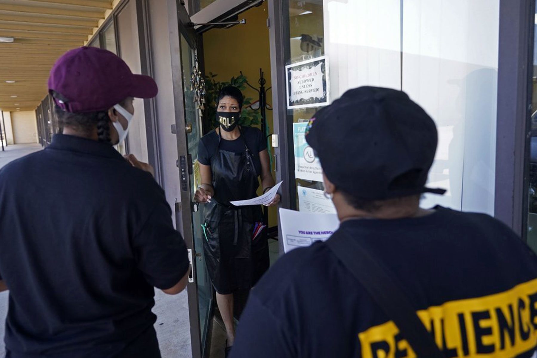 An outreach team goes door to door to educate the community on vaccines.