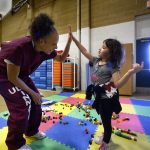 A mother plays with her daughter during a visit in prison.