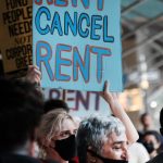 Protester holding a sign that says cancel rent.