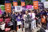 Group gathered around a woman protesting abortion measures.