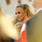 Britney Spears is seen wearing a red dress at a movie premiere.