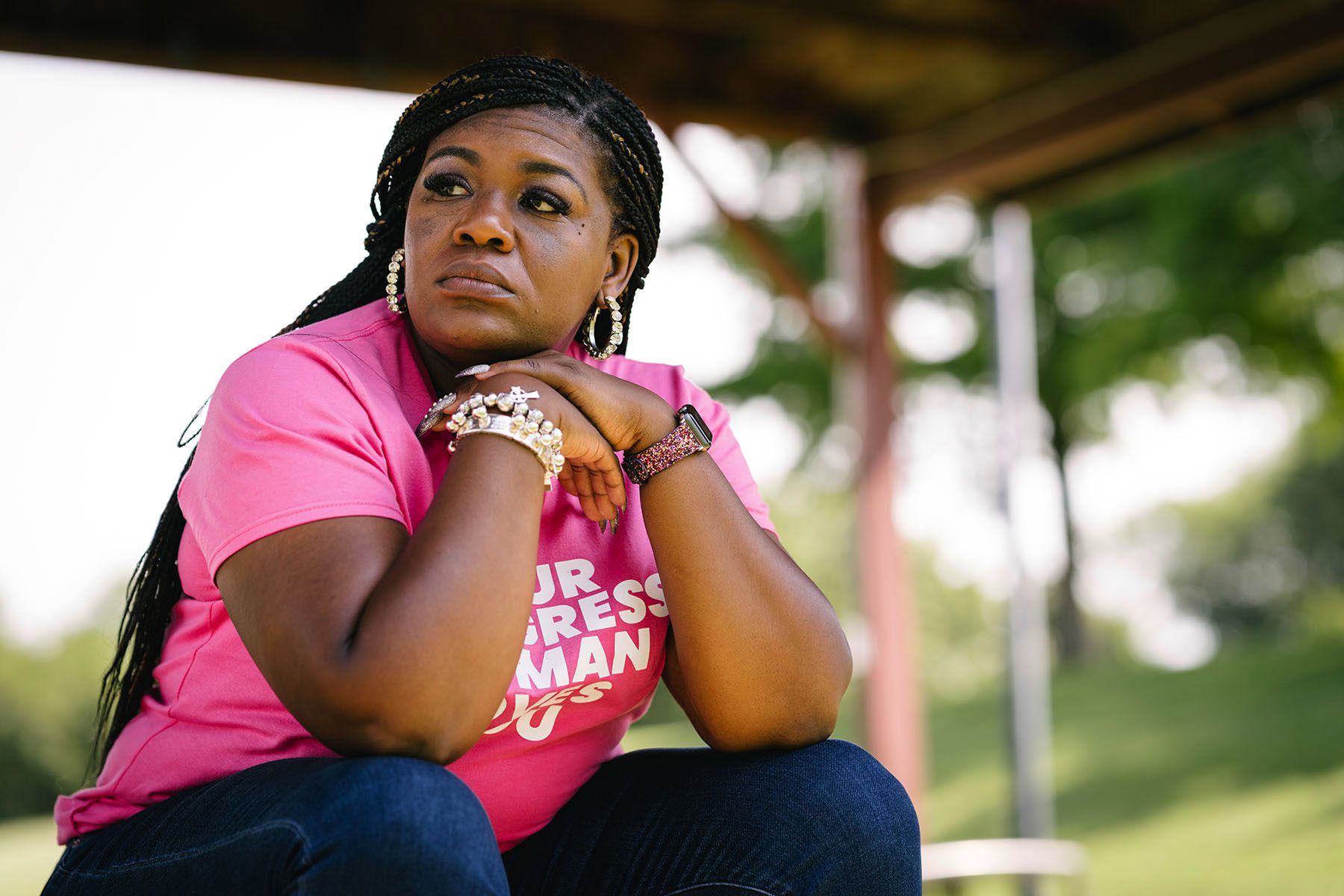 Cori Bush looks out onto the distance, resting her head on her hands.