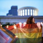 A woman and a child hold a trans pride flag in during a rally.