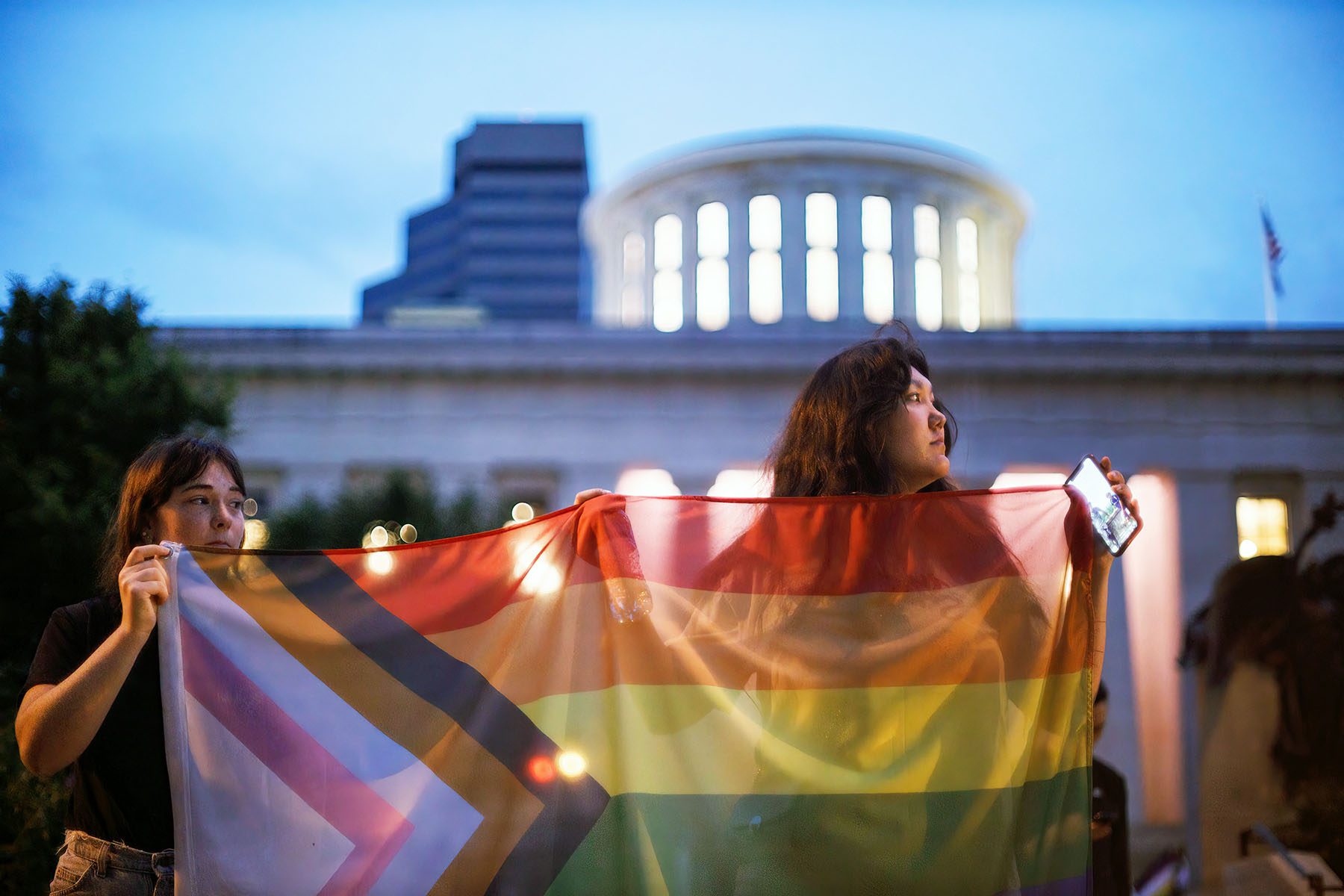 A woman and a child hold a trans pride flag in during a rally.