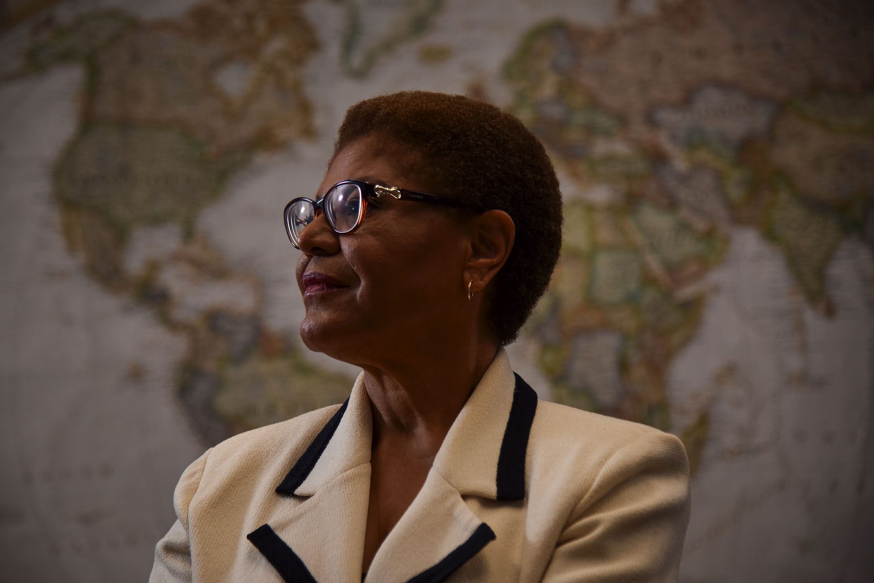 Karen Bass poses for a portrait in front of a wold map.