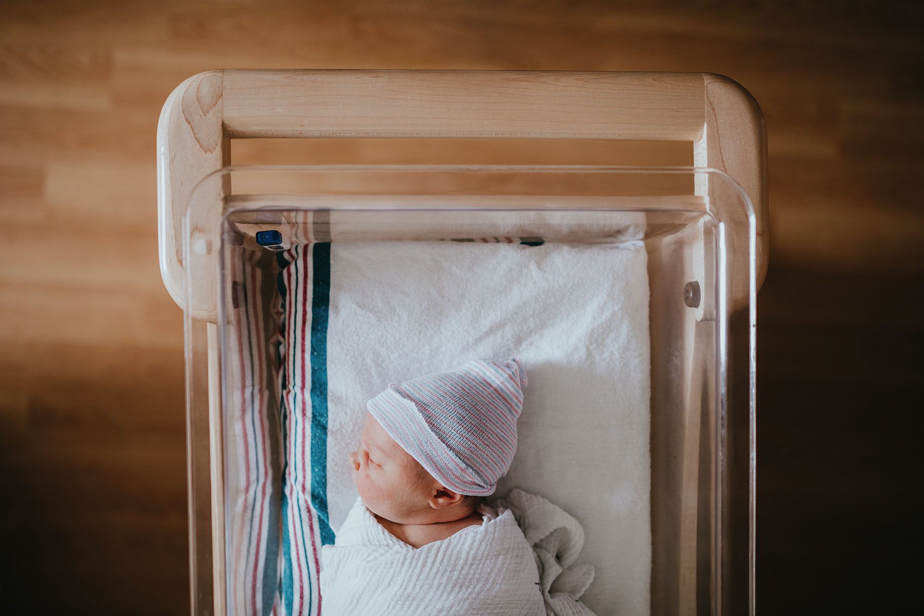 Newborn baby sleeping in a hospital bassinet