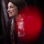 Sen. Amy Klobuchar looks to the side and smiles.