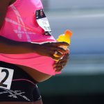 Alysia Montano holds a bottle of Gatorade to her pregnant belly.