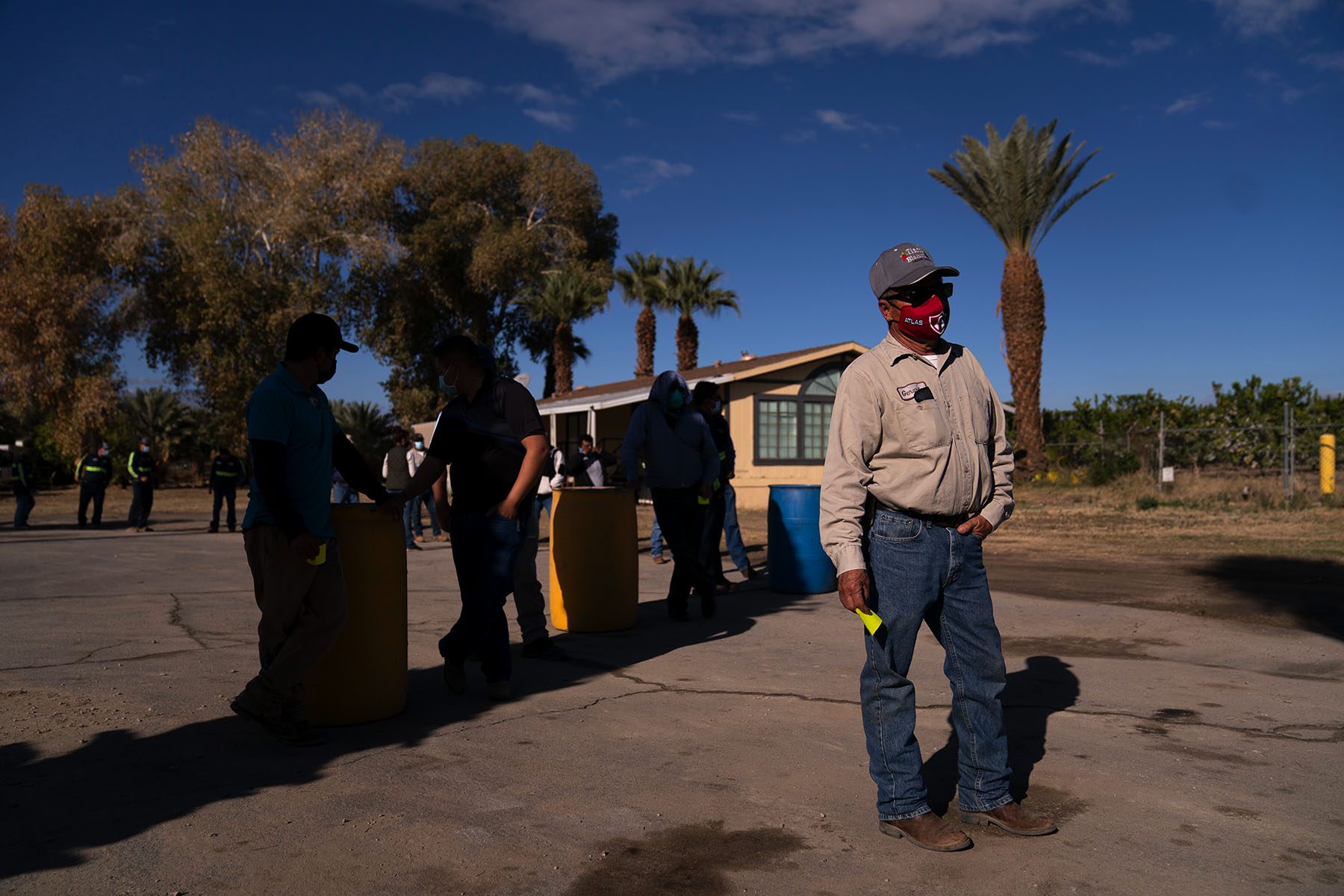 Farm workers wait in line at a California ranch.