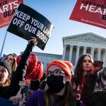 pro and anti-abortion rights activists gather outside the Supreme Court.