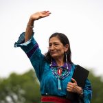 Secretary of the Interior Deb Haaland waves to the crowd.