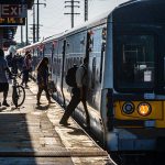 Commuters board a train at a Long Island Rail Road station.