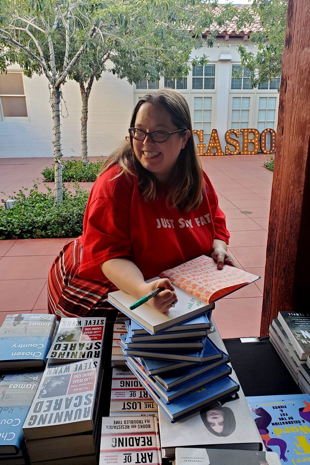 Angie Manfredi signs a book.