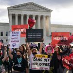 Abortion activists and anti-abortion demonstrators rally in front of the Supreme Court.