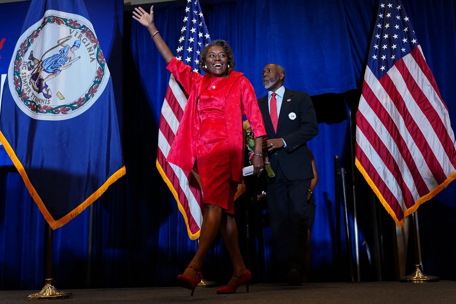 Winsome Sears wave hand while walking onto a stage.