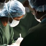 A woman surgeon and her assistants operating on a patient.