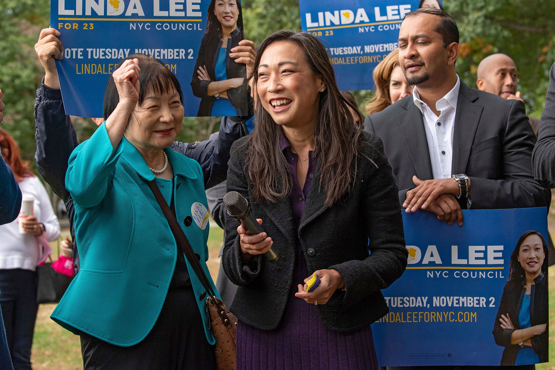 Linda Lee is surrounded by supporters as she speaks.