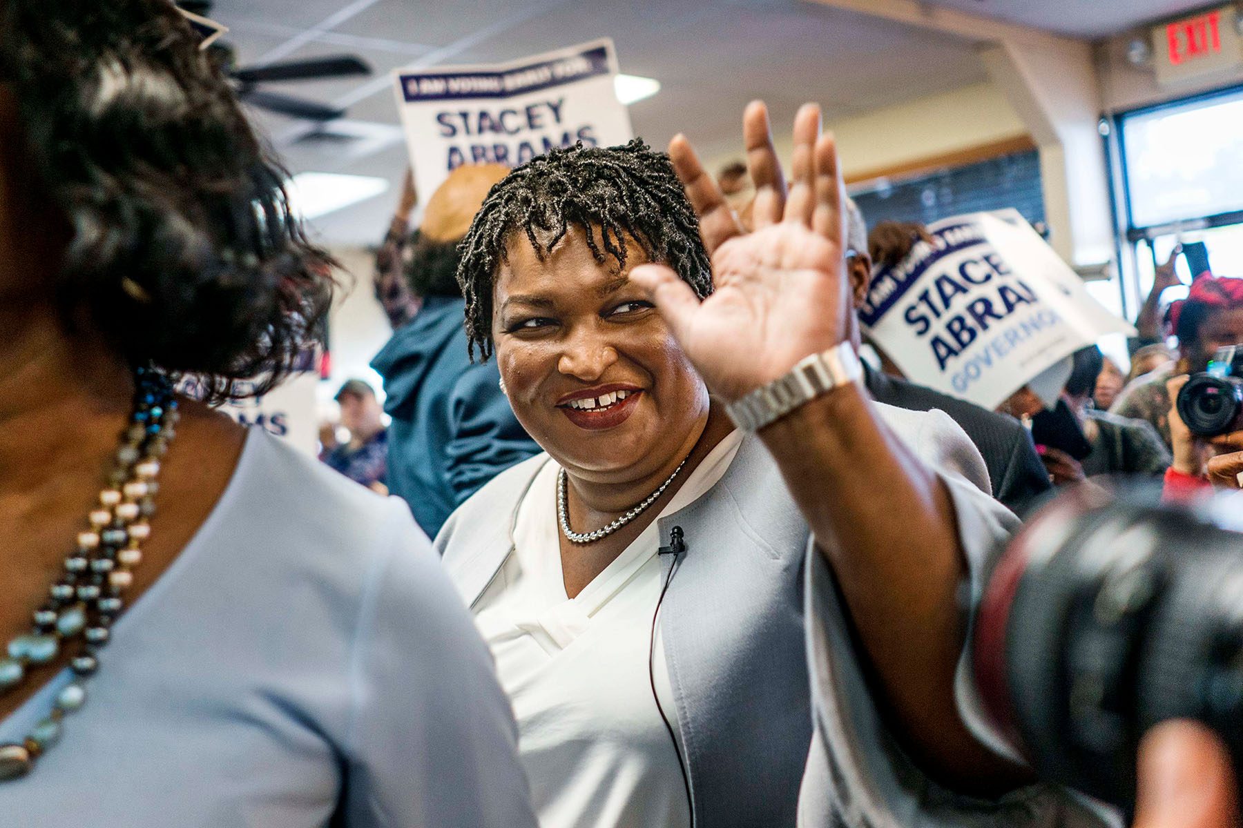 Stacey Abrams smiles and waves as meets Georgia voters.