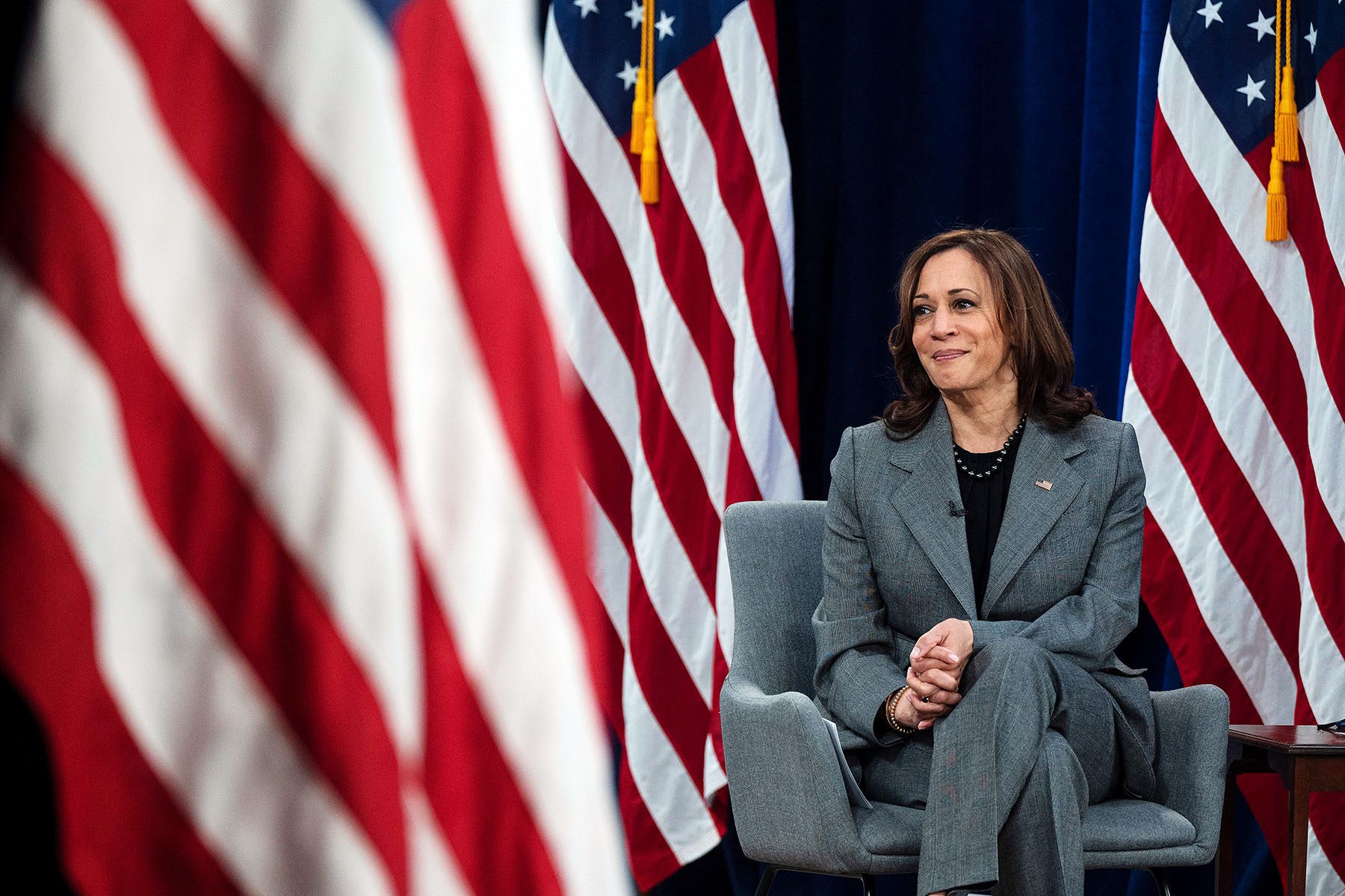 Kamala Harris listens during a conversation with Olympic athlete Allyson Felix.