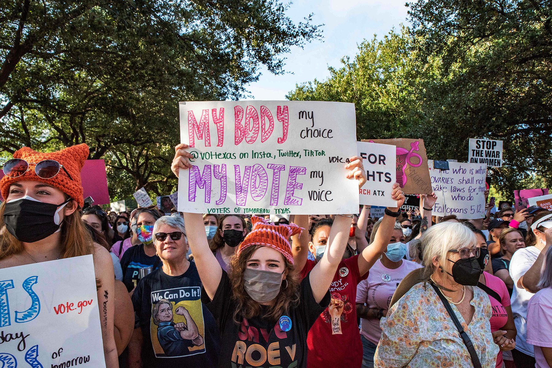 Protesters carry pro-abortion rights signs and march.