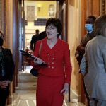 Sen. Susan Collins smiles as she speaks to reporters on Capitol Hill.