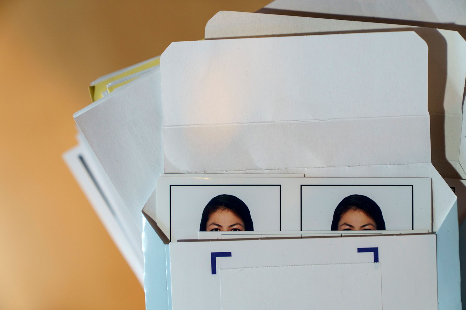 The photo of an Afghan woman hoping to flee Afghanistan sits with her application.