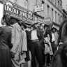 People dressed to the nines wait in line at the entrance of a cabaret.