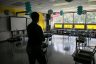 A woman superintendent looks over an empty classroom.