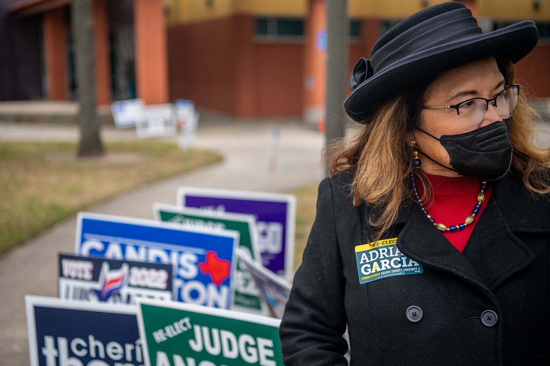 A volunteer waits near a polling station.