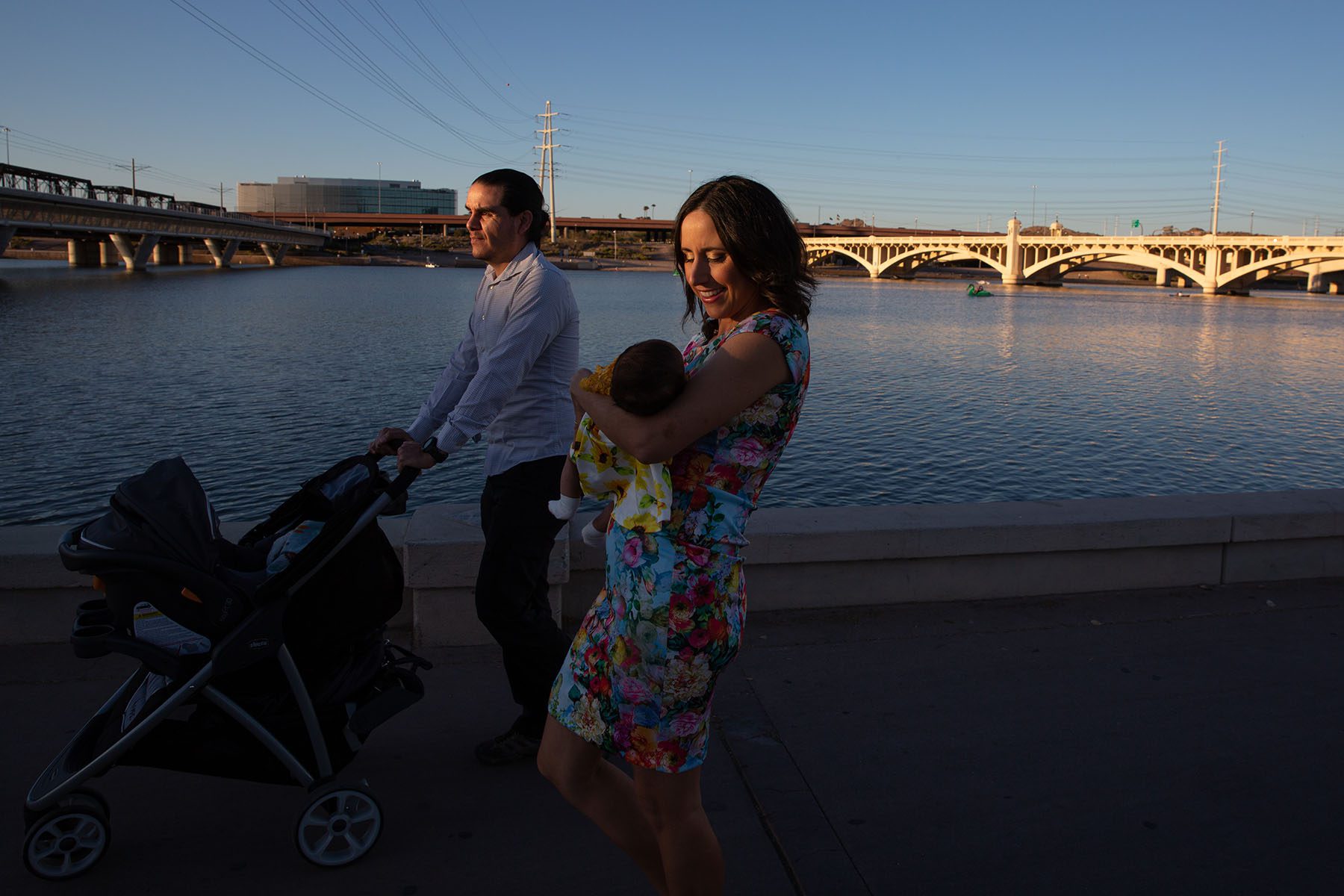 Sen. Juan Mendez and Rep. Athena Salman take a walk with their daughter near the water at Tempe Beach Park.