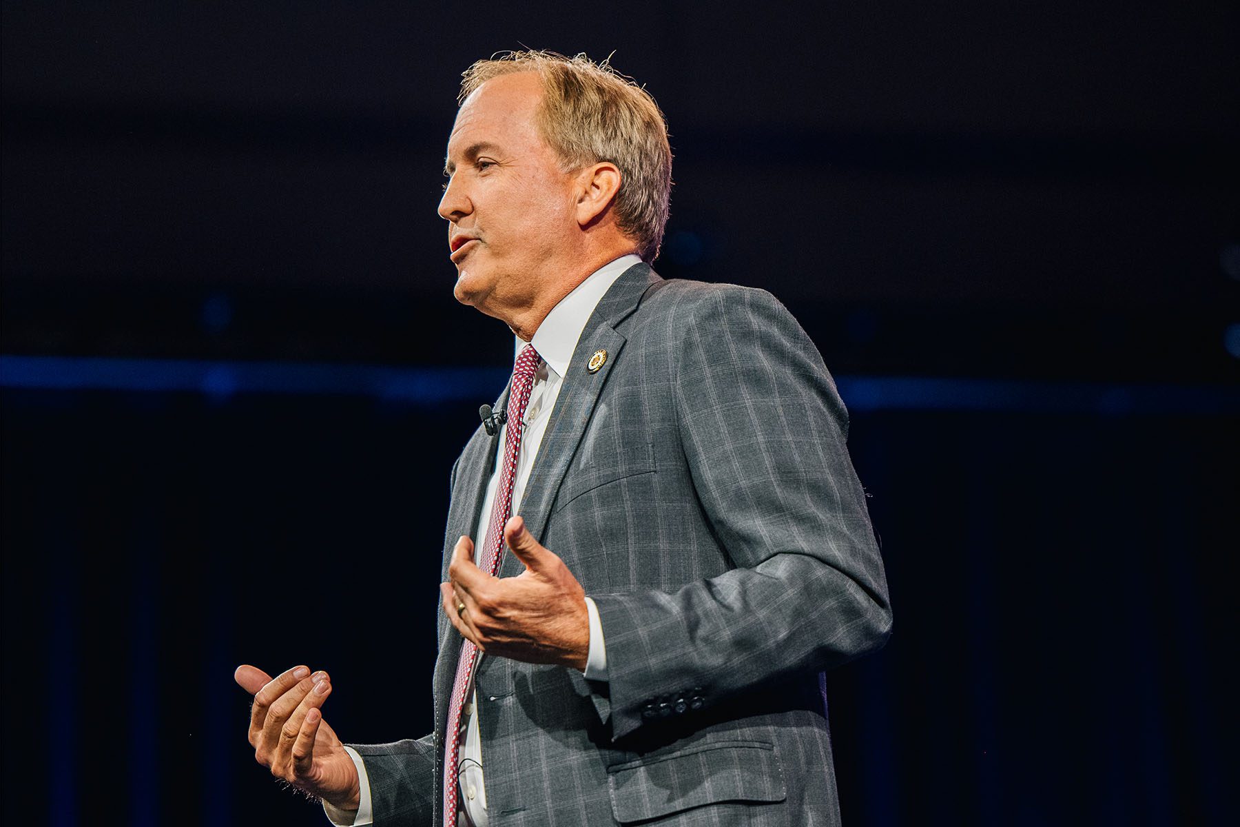 Texas Attorney General Ken Paxton speaks at a conference.