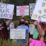 A group of protesters hold signs backing abortion rights.