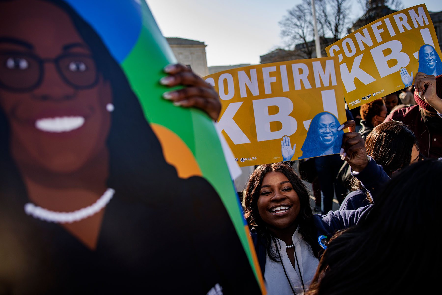 Law students hold up signs that read "Confirm KBJ" at a rally outside the U.S. Supreme Court.