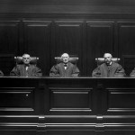 View of a courtroom interior, circa 1890. Five robed judges are shown seated at the bench.