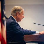 Texas Governor Greg Abbott glances at his notes as he prepares to speak during a conference.