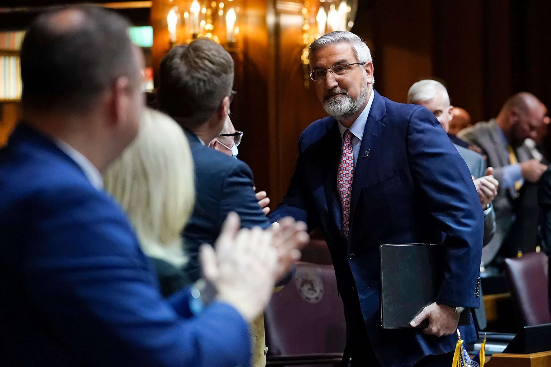 Indiana Gov. Eric Holcomb talks with representatives.