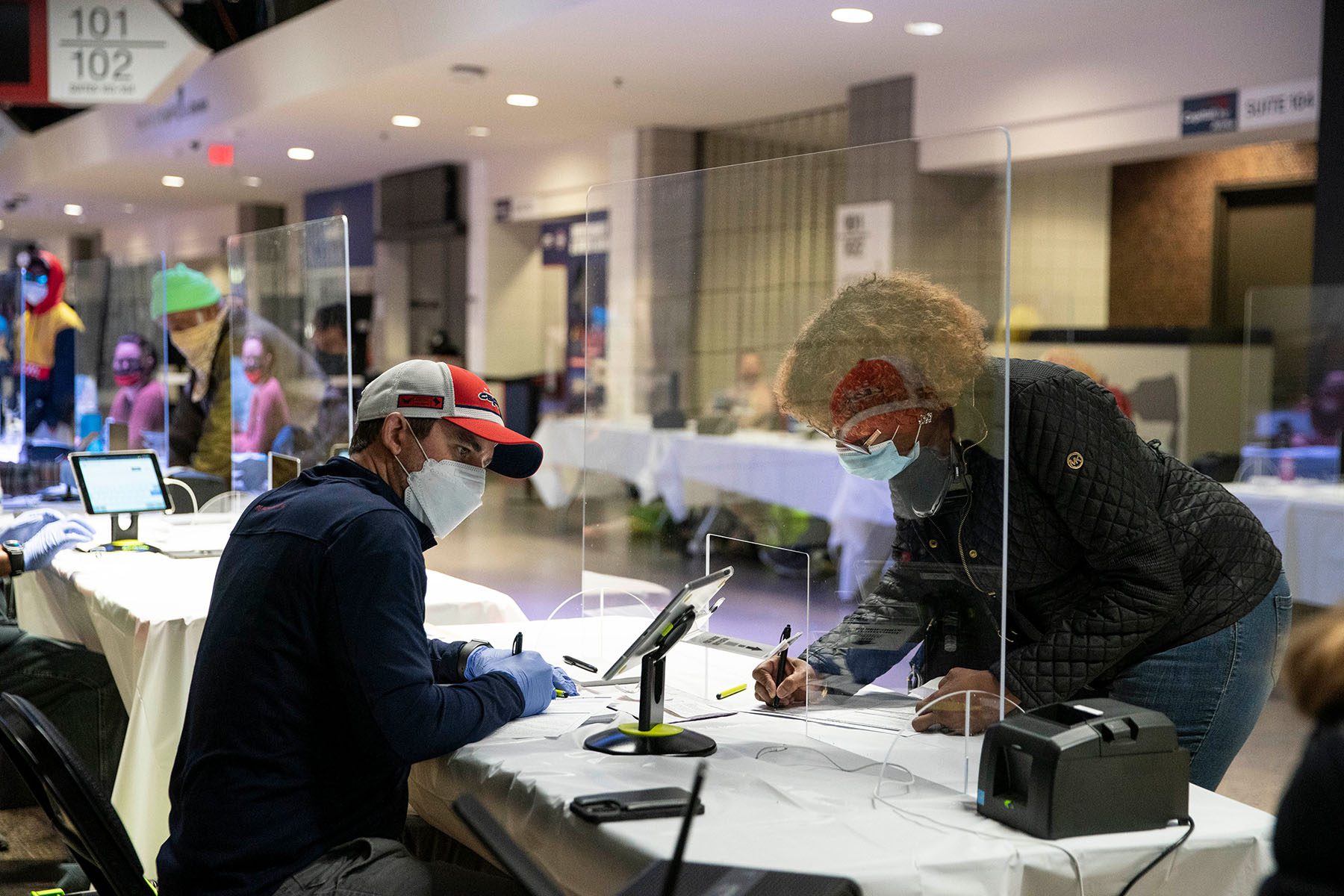 A woman checks into a polling station.