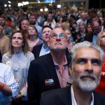 A crowd watches a campaign film as they attend a primary night election party for Republican gubernatorial candidate Gov. Brian Kemp.