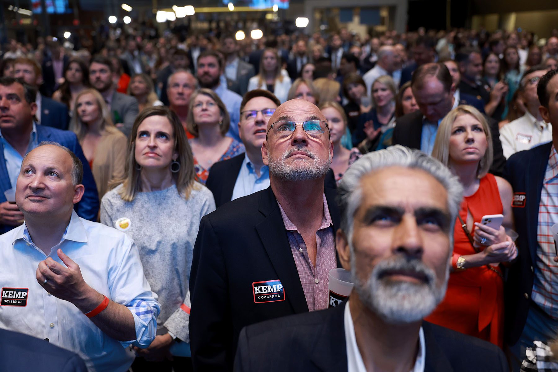 A crowd watches a campaign film as they attend a primary night election party for Republican gubernatorial candidate Gov. Brian Kemp.